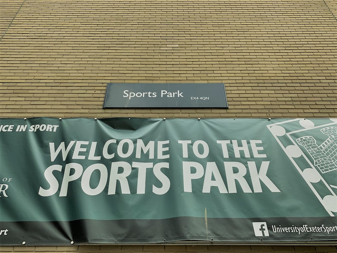 "Welcome to the Sports Park" banner on the wall of the Sports Park building on Streatham Campus