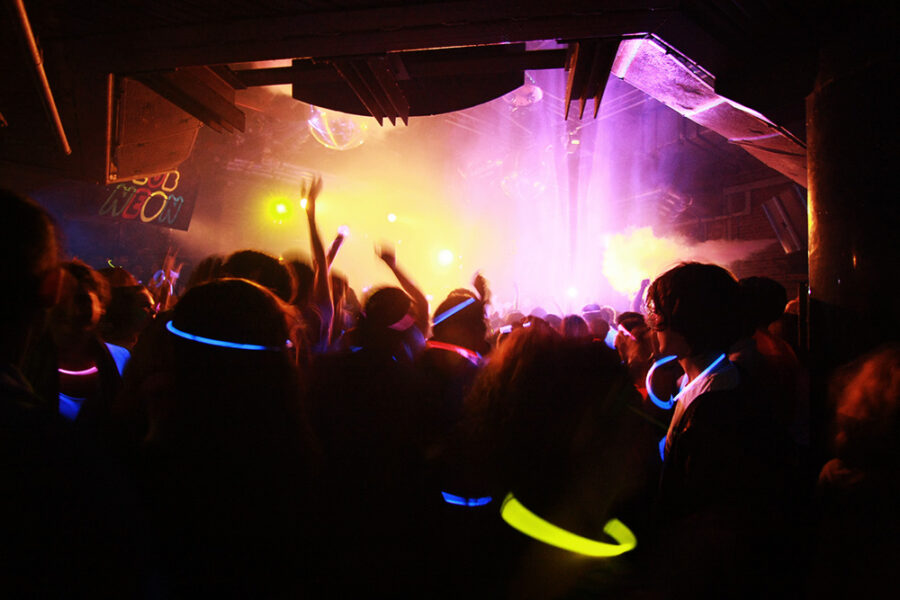 Silhouetted people dancing in nightclub